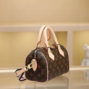 Alternative view of The Speedy 20 bag in Damier Ebène canvas exudes the timeless allure of Louis Vuitton. Whether carried by hand, over the shoulder, or crossbody, it radiates effortless elegance. The novel colored shoulder strap adds a touch of fashion-forward flair! Dimensions: 20 x 13.5 x 11.5 cm.